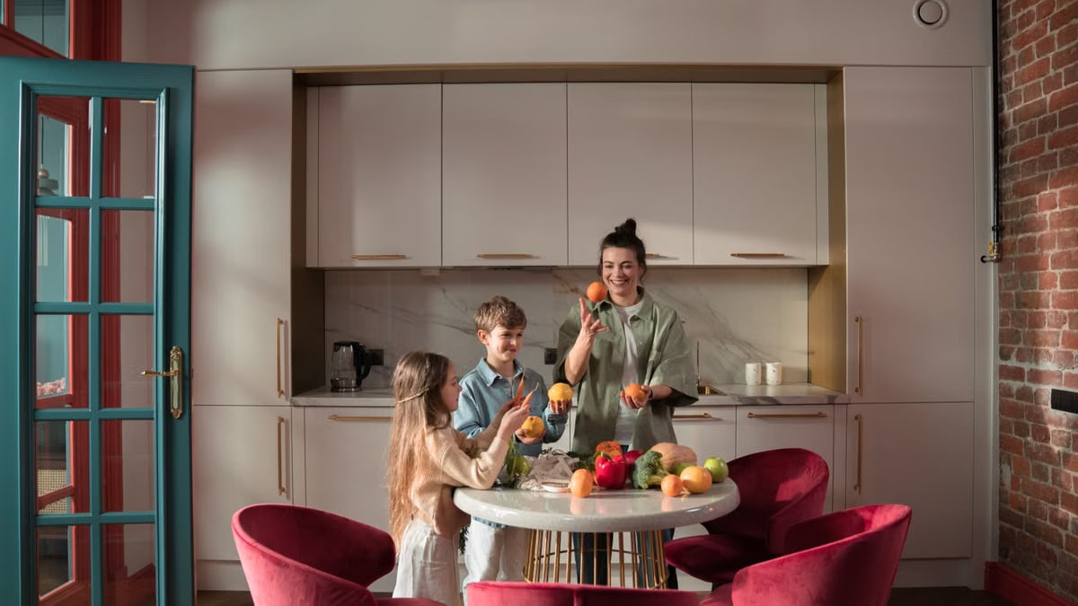 Mother with children preparing meals with fresh ingredients in a modern kitchen.